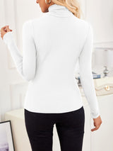 Back view of VRCÔMFY satin white turtleneck top with sculpted silhouette, styled with noir black trousers and oat beige bag with gilded hardware | Architectural minimalism and metropolitan elegance in a curated lifestyle composition