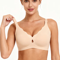 Woman wearing a beige bra on a plain background