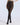A model wearing high-waisted sheer black tights against a light gray studio background.