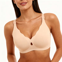 Woman wearing a beige bra on a white background