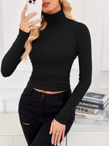 VRCÔMFY black turtleneck cropped top with contour-defining fit, styled with distressed black jeans against an intellectual studious backdrop | Urban minimalist edge meets literary aesthetic in versatile wardrobe essentials