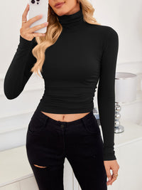 VRCÔMFY head-to-toe black ensemble with cropped turtleneck top and precision-tailored trousers | Razor-sharp minimalism and disciplined refinement for powerful urban styling