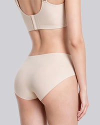Rear view of a model wearing a matching beige bra and high-waisted shapewear briefs against a solid gray background.