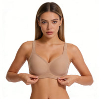 Woman wearing a beige bra on a white background