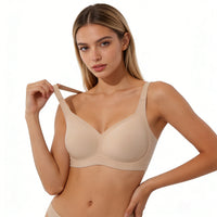 Woman wearing a beige bra on a white background