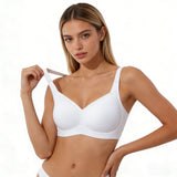 Woman wearing a white bra on a plain background