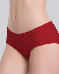 A close-up of a model wearing a solid deep red high-waisted brief against a light gray background.