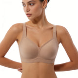 Woman wearing a beige bra on a white background