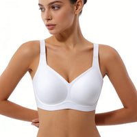 Woman wearing a white bra on a plain background