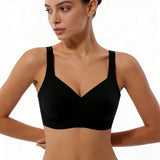 Woman wearing a black sports bra against a neutral background