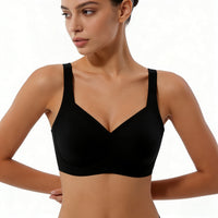 Woman wearing a black sports bra against a neutral background