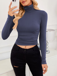 VRCÔMFY navy ink blue cropped turtleneck top with architectural tailoring, paired with precision-cut black trousers | Sculpted minimalism and metropolitan refinement for elevated urban style