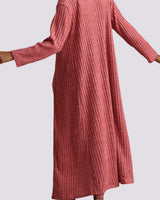 A ribbed knit long-sleeve maxi dress in a dusty rose pink color, shown on a model against a light gray background.