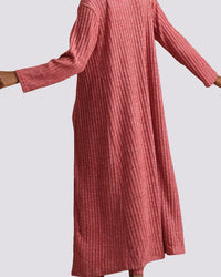 A ribbed knit long-sleeve maxi dress in a dusty rose pink color, shown on a model against a light gray background.