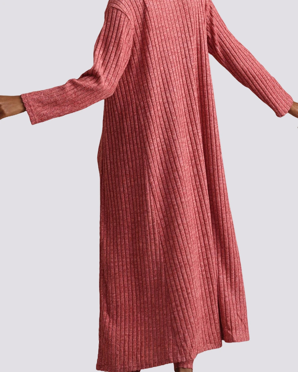 A ribbed knit long-sleeve maxi dress in a dusty rose pink color, shown on a model against a light gray background.