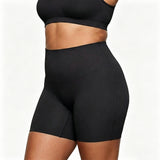 Black athletic shorts worn by a person on a white background