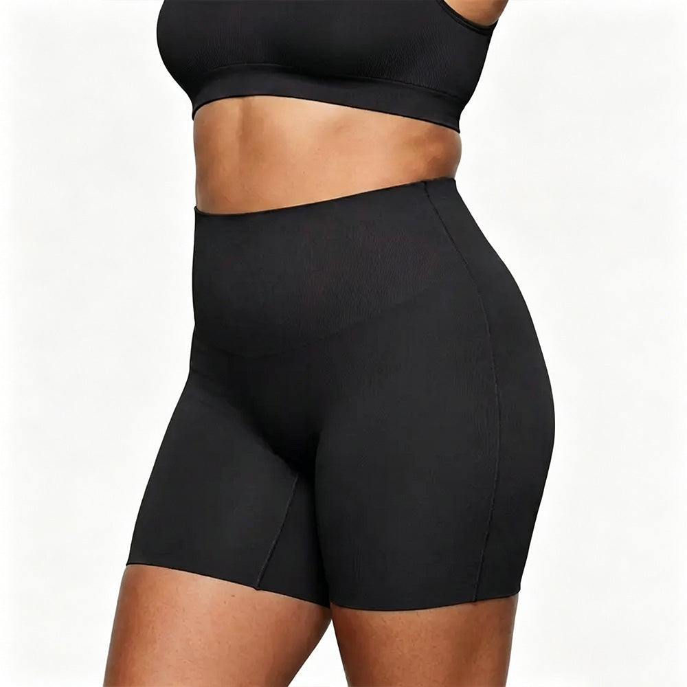 Black athletic shorts worn by a person on a white background