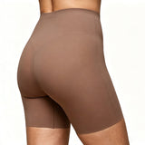 Brown athletic shorts worn by a person on a white background