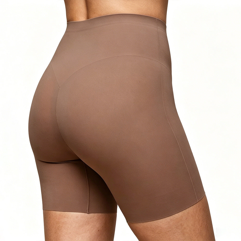 Brown athletic shorts worn by a person on a white background