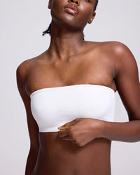 VRCOMFY Black strapless top worn by a model on a gray background