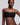 A woman modeling a black strapless bandeau-style bra against a light gray studio background.