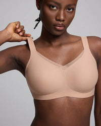 VRCÔMFY nude uplift wireless bra with sheer mesh accents and adjustable straps | Engineered with targeted support panels for enhanced cleavage and sculpted shape