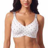 A woman wearing a VRCOMFY white wireless bra with black polka dots and gray patterned shoulder straps, shown from the chest up against a plain white background.