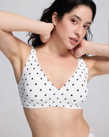 VRCOMFY White polka dot bralette worn by a person on a gray background