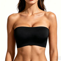 Black strapless top worn by a model on a white background
