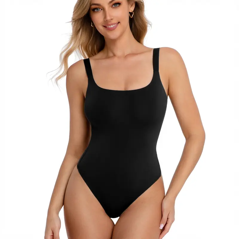 Woman wearing a black one-piece swimsuit on a white background