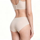 Beige shapewear top and shorts on a white background