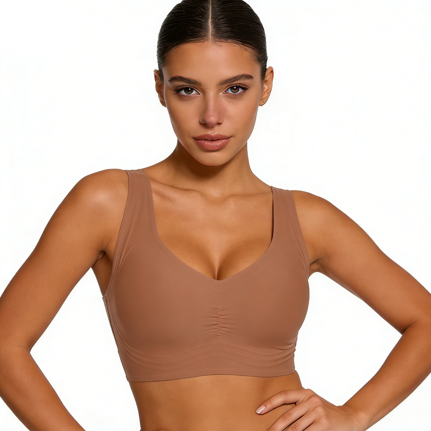 Woman wearing a brown sports bra on a white background