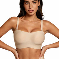 
Woman wearing a beige bralette against a plain background