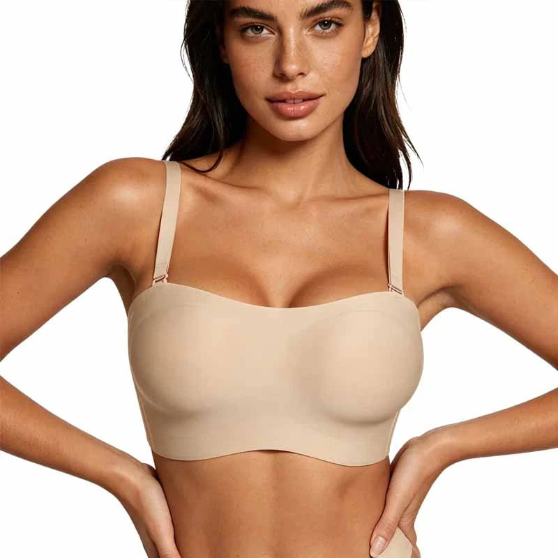 
Woman wearing a beige bralette against a plain background