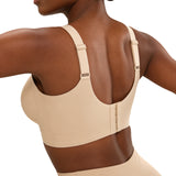 Beige compression garment worn by a model on a white background