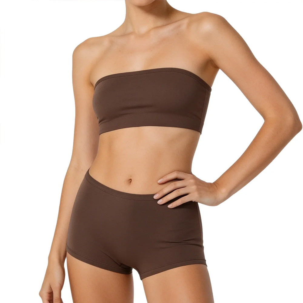 Female model wearing a brown seamless strapless top and shorts set, showcasing a comfortable and minimalistic design on a white background