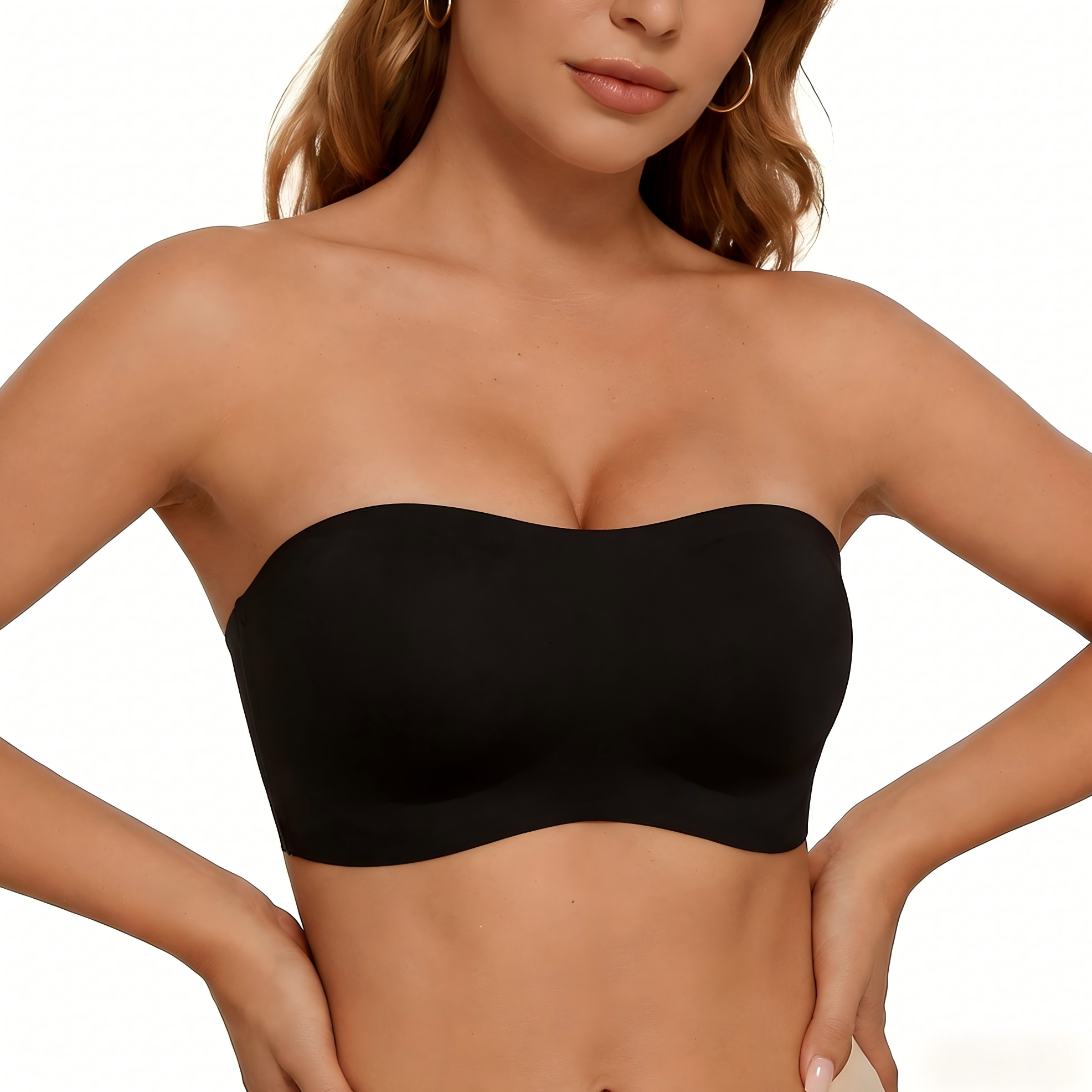 Woman wearing a black strapless top against a neutral background
