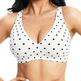 White polka dot bralette worn by a person on a white background