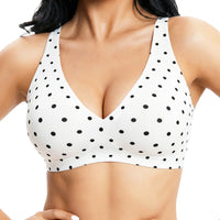 White polka dot bralette worn by a person on a white background