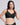 A woman modeling a  VRCOMFY black wireless bra with a V-neckline against a solid light gray background.