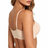 Rear three-quarter view of a woman wearing a light beige wireless bra with thin adjustable shoulder straps and small decorative metal rings, against a plain white background.