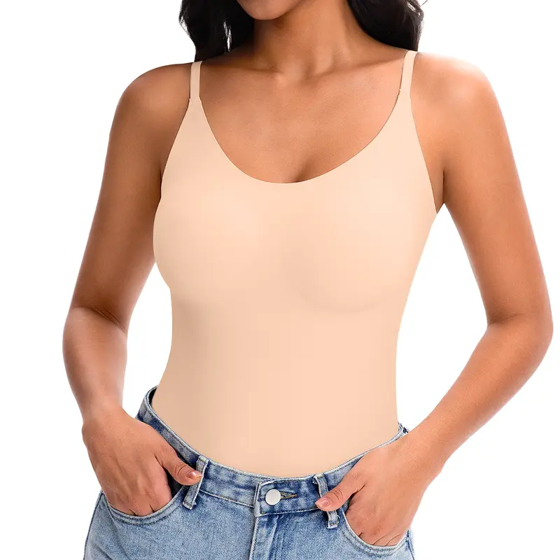 Person wearing a beige tank top and blue jeans on a white background