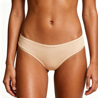 Beige bikini bottom worn by a person on a white background
