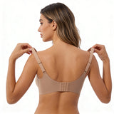 Woman wearing a beige bra on a white background
