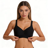 Woman wearing a black sports bra on a white background