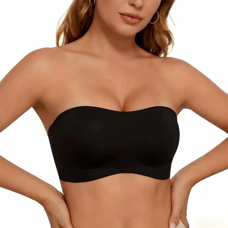 Black strapless top worn by a model on a plain background