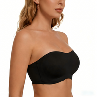 Black strapless bra worn by a model on a white background
